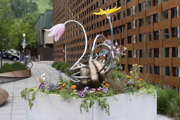 Image of Kelly Akashi bronze hand sculpture with glass flowers, side view