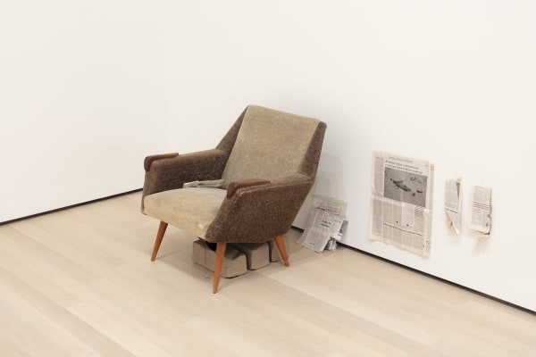 Image of Mark Manders installation, factory with clay figure and chair
