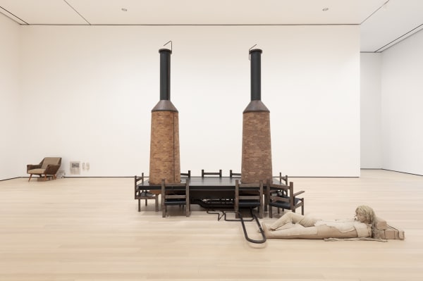 Image of Mark Manders installation, factory with clay figure and chair