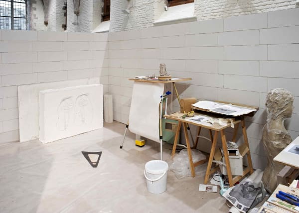image of mark manders sculptures and studio set up inside a concrete room block