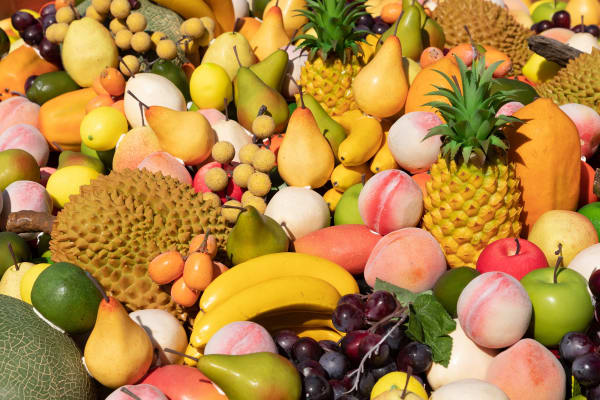 image of a crate floating in the river with fake fruit inside