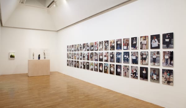 Installation view of Gillian Wearing at Whitechapel Gallery, London, photographs of people holding signs