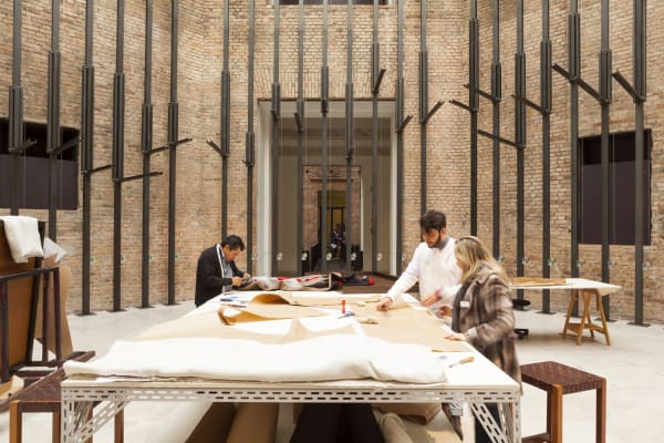 image of tailors sewing / working in a tailor shop set up inside museum