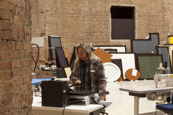 image of tailors sewing / working in a tailor shop set up inside museum