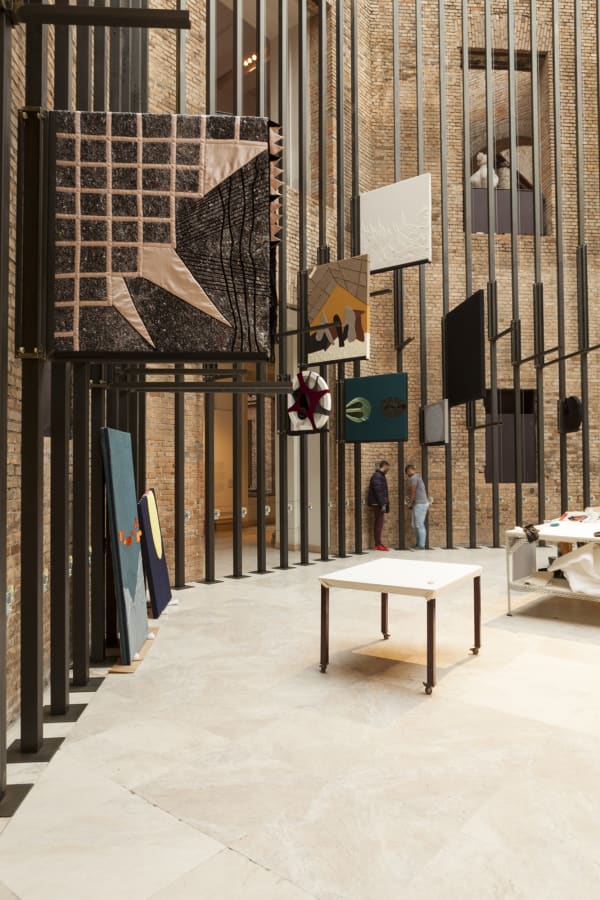 image of tailors sewing / working in a tailor shop set up inside museum