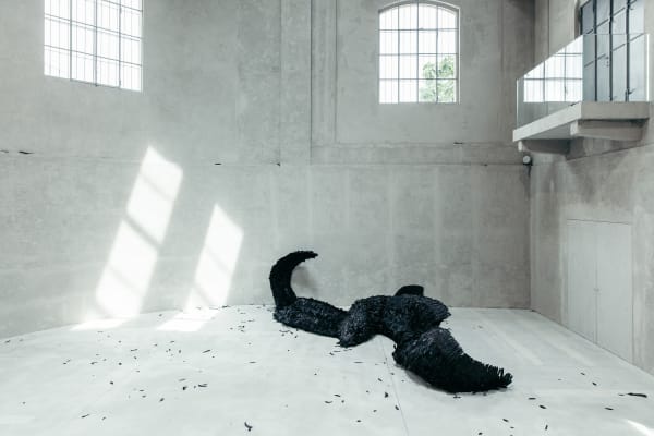 image of a sculpture of a large fallen black bird
