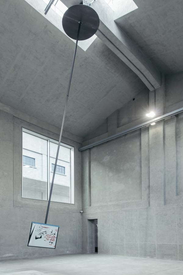 image of a large pendulum with a drawing on it