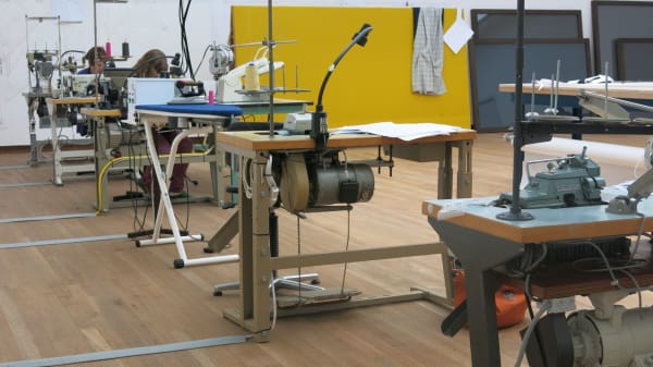 image of a tailor shop set up in museum, sewing machines