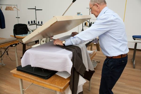 image of a tailor shop set up in museum, tailor working
