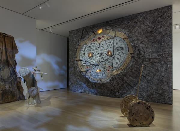 image Charles Long sculptural installation in darkened gallery space, large strump relief