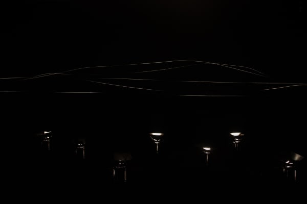 image of spotlit spider webs in dark room