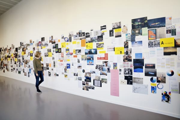 image of paper and newspaper articles on a wall