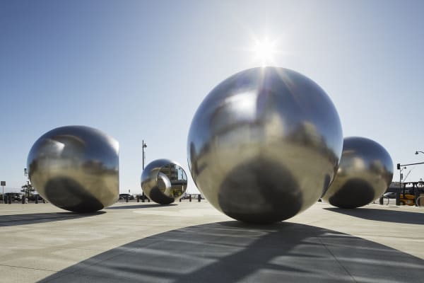 image of 5 large steel spheres with truncated mirror