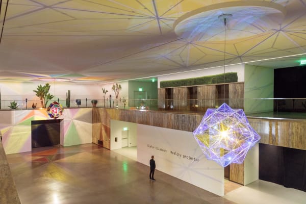 image of installation view, with two large geometric lamps