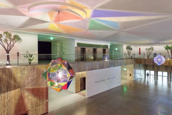 image of installation view, with two large geometric lamps