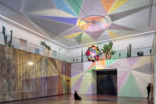 image of installation view, with two large geometric lamps