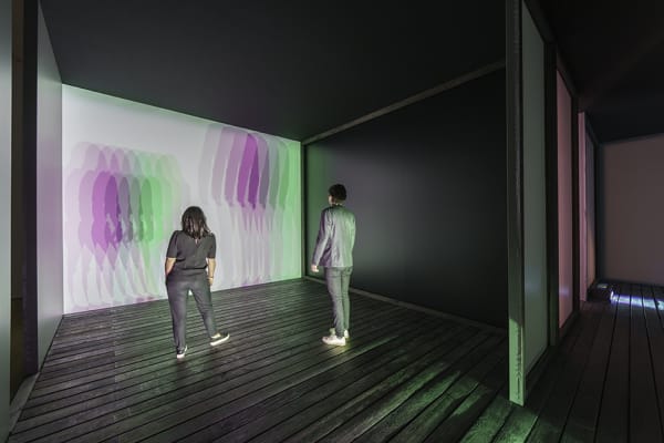 room with lights creating shadows of people