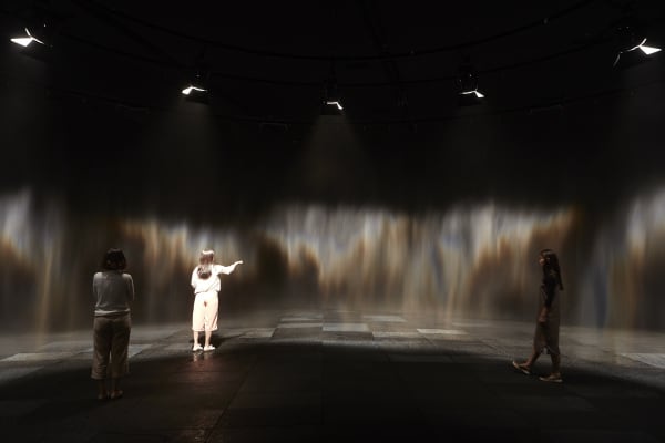 image of mist creating a rainbow in a dark room