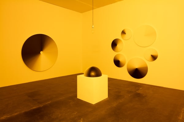 image of installation of paintings in monofrequency light