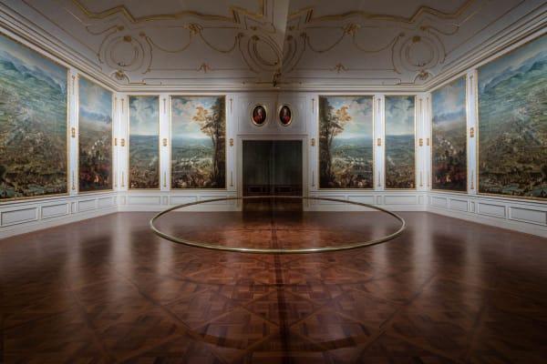 room with circular sculpture in the middle