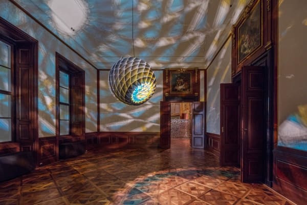 image of light sculpture with projections on the walls