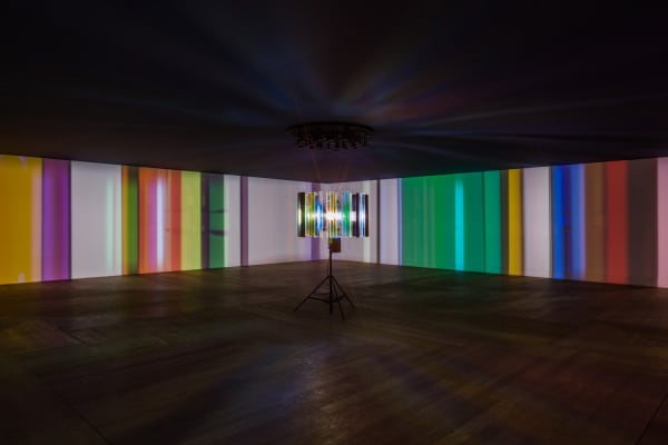 dark room with center light projecting stripes on the walls