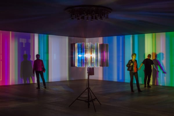 dark room with center light projecting stripes on the walls