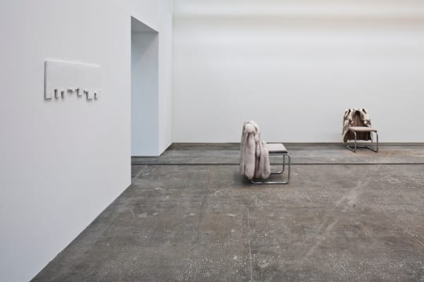image of chairs with fur coats hanging off of them