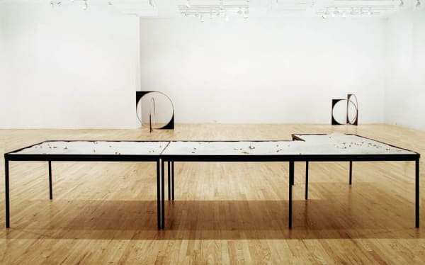 image of Nicole Wermers circular sculpture with table of sand and cigarettes