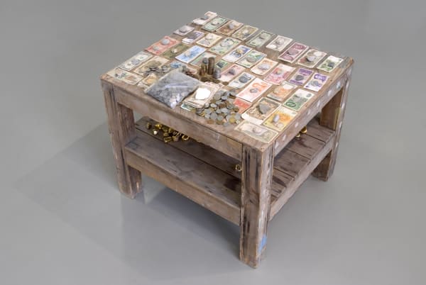 installation view of sculptures, currency on the table