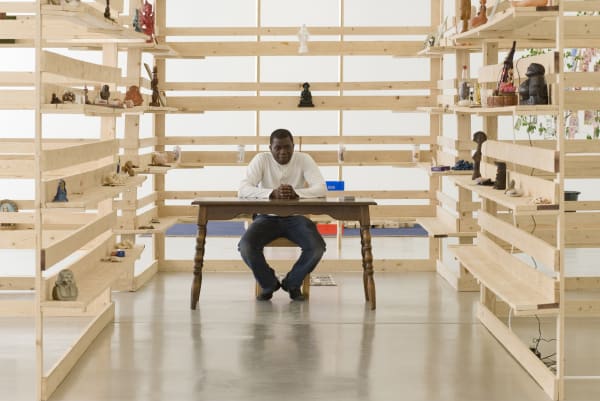 Meschac Gaba sitting at table