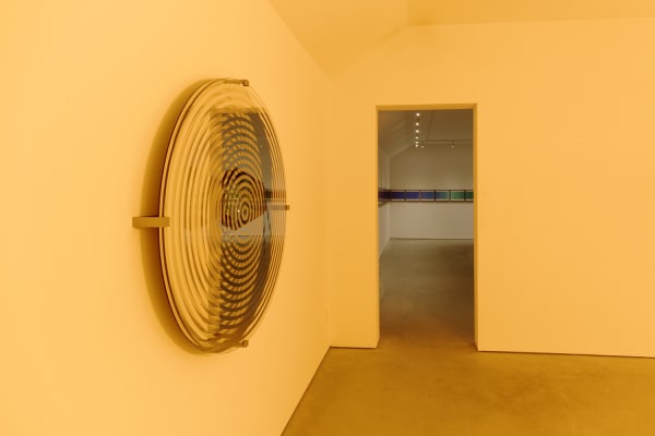image of yellow room with wall sculptures