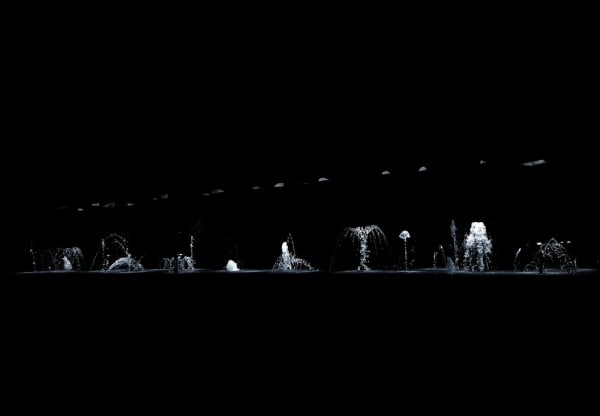 image of dark room with spotlights on water