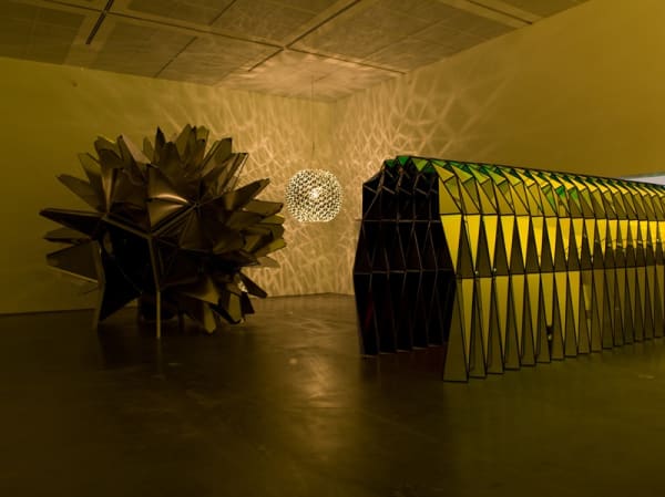 image of three sculptures in darkened room