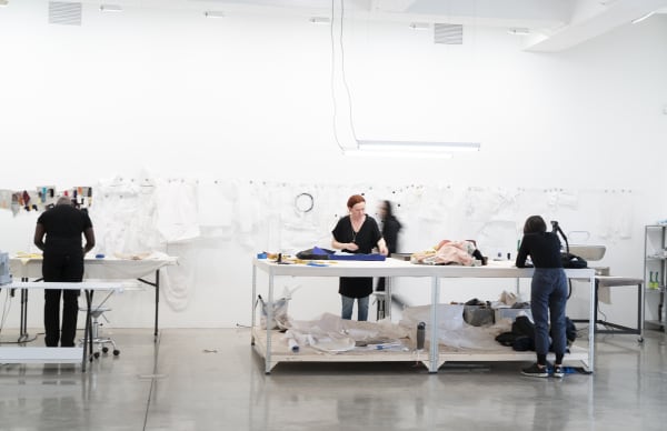Laura Lima tailor shop install photo - tailors working