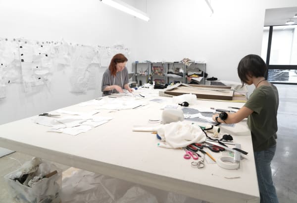 Laura Lima tailor shop install photo - tailors working