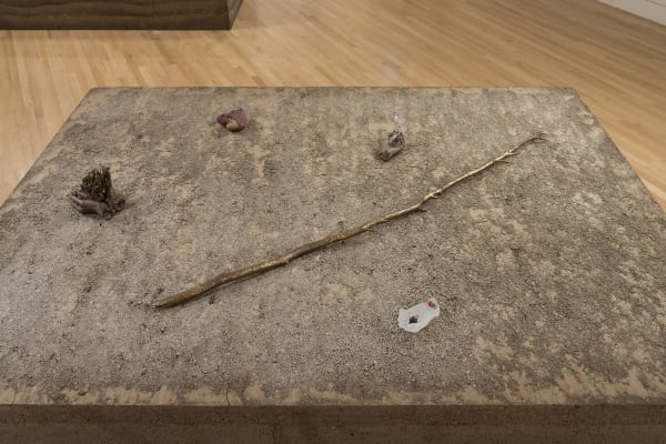 small sculptures on top of an earthen pedestal