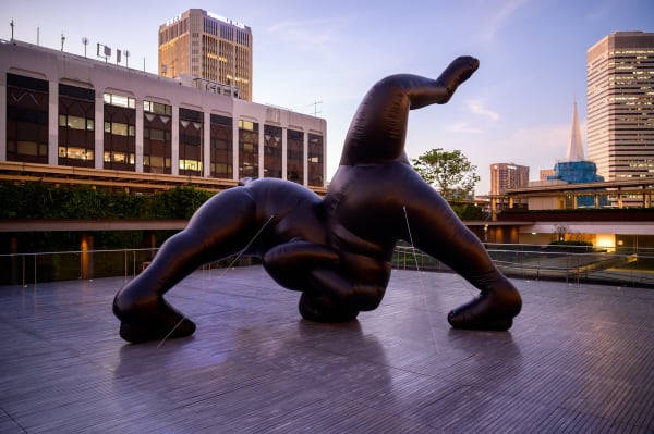 Shilpa Gupta's Untitled inflatable sculpture installed outdoors with cityscape backdrop