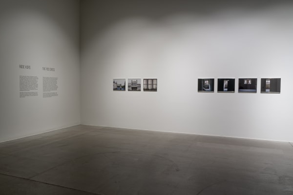 Susan Philipsz's film still image, two channel projection of concrete building facades in dark room