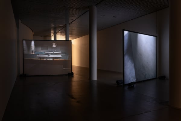 Susan Philipsz's film still image, two channel projection of concrete building facades in dark room