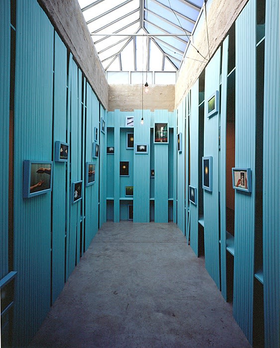 Cinto blue structure under skylight with photographs