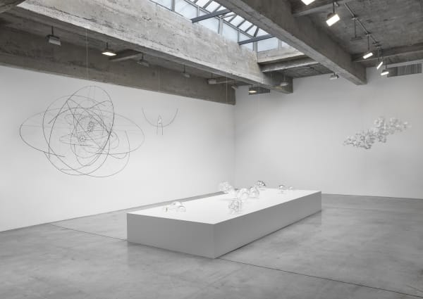 Saraceno glass objects on table and hanging sculptures