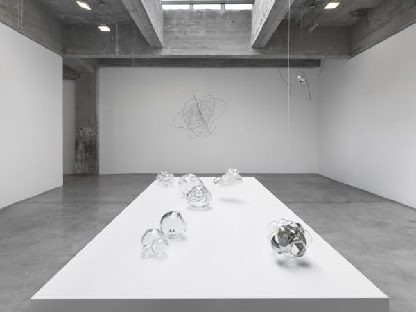 Saraceno glass objects on table and hanging sculptures