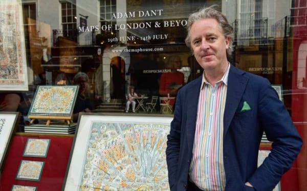 The artist Adam Dant in front of The Map House's shop window