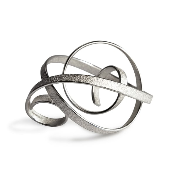 Ute Decker, Curling Crest of a Wave, sculptural ring, 2014/15, 100% recycled silver, private collection of Helen Drutt - part of Rings! exhibition A similar hand sculpture to the one pictured is part of the Rings! exhibition. Each ring in the “Curling Crest of a Wave” (for short “Curl”) series is free-form hand sculpted thus each piece is unique. It can also be worn as a pendant.