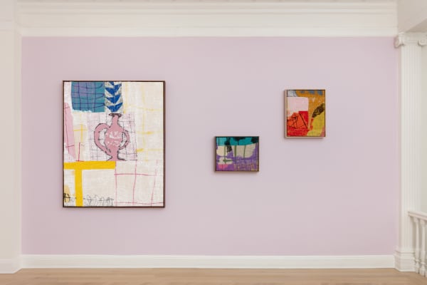 installation view of abstract paintings in multiple colors on burlap