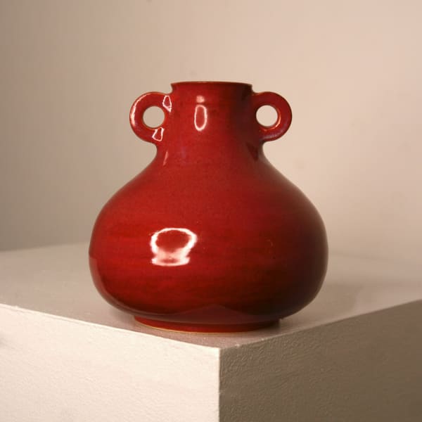 Lucy Physick stoneware ceramic tear drop shaped vase in a coral glaze