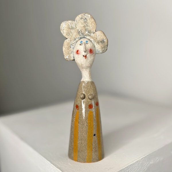 Jane Muir ceramic sculpture of a little lady with stoneware glaze with orange stripes and red dots