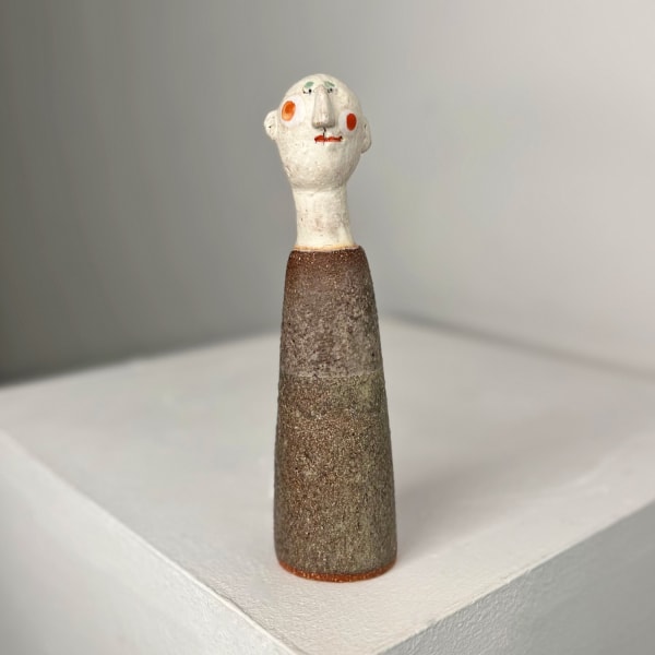 Jane Muir sculpture of a little man wearing a pink shirt smock