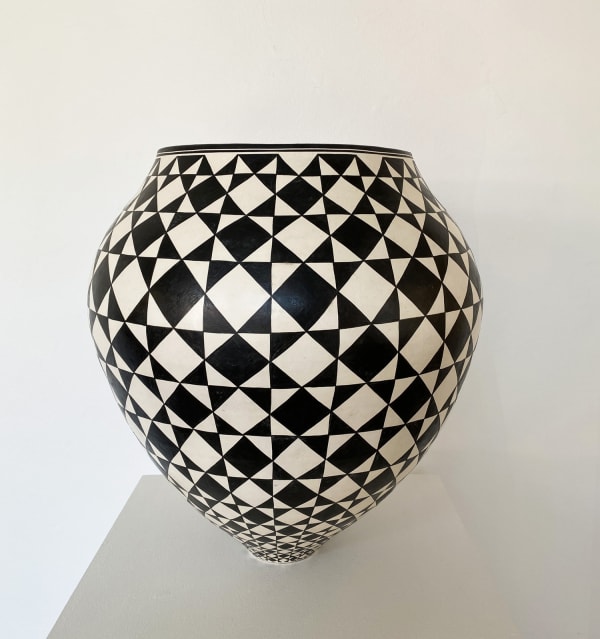 Ant & Di Edmonds - Tydd Pottery wide, round ceramic black and white vessel with a complex diamond pattern.